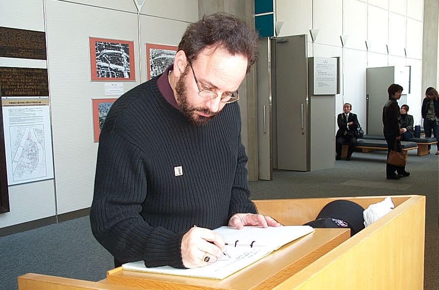 Signing guest book at Hiroshima peace museum.